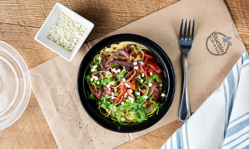 Take out salad on a paper bag